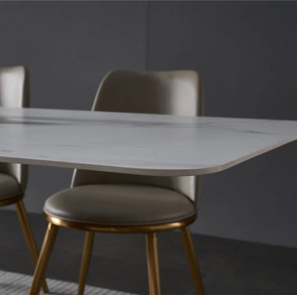 Modern White Marble Dining Table with Golden V-Shaped Base & Beige Chairs
