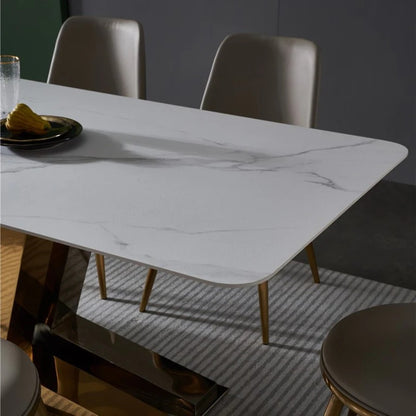Modern White Marble Dining Table with Golden V-Shaped Base & Beige Chairs