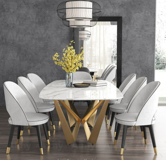 Modern White Marble Dining Table with Golden Geometric Base & Black Chairs –